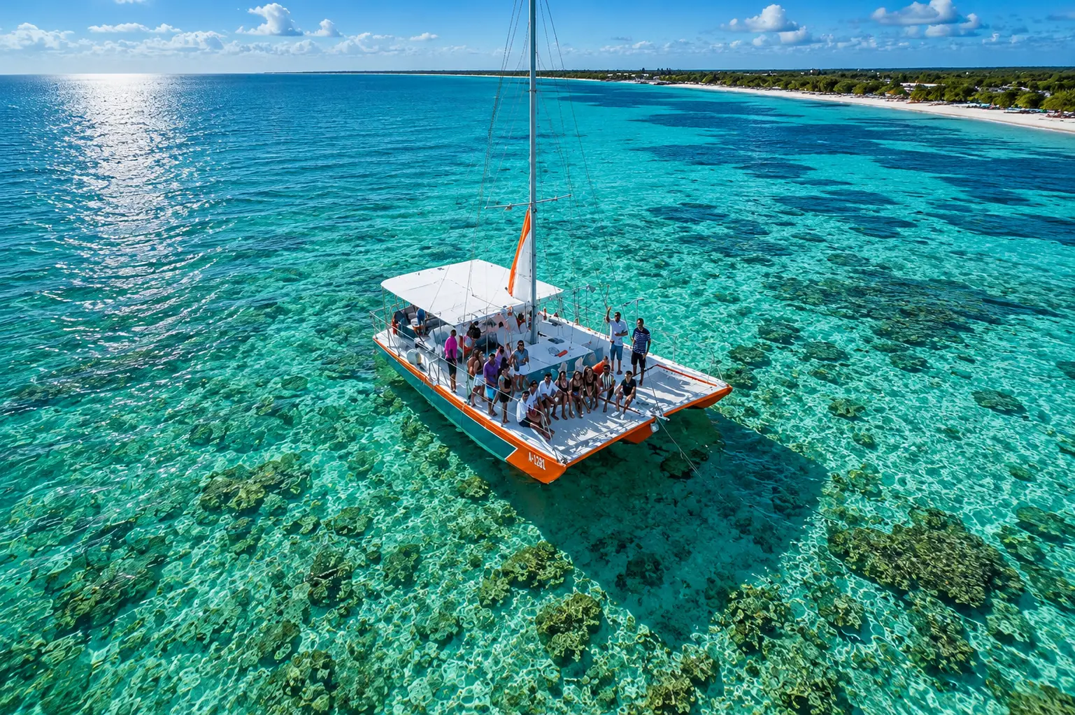 Aerial view of a catamaran with guests over the coral reef on an Aruba boat tour