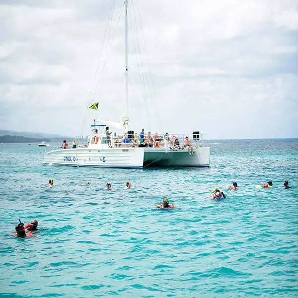 Catamaran with snorkelers in turquoise water off Ocho Rios, Jamaica