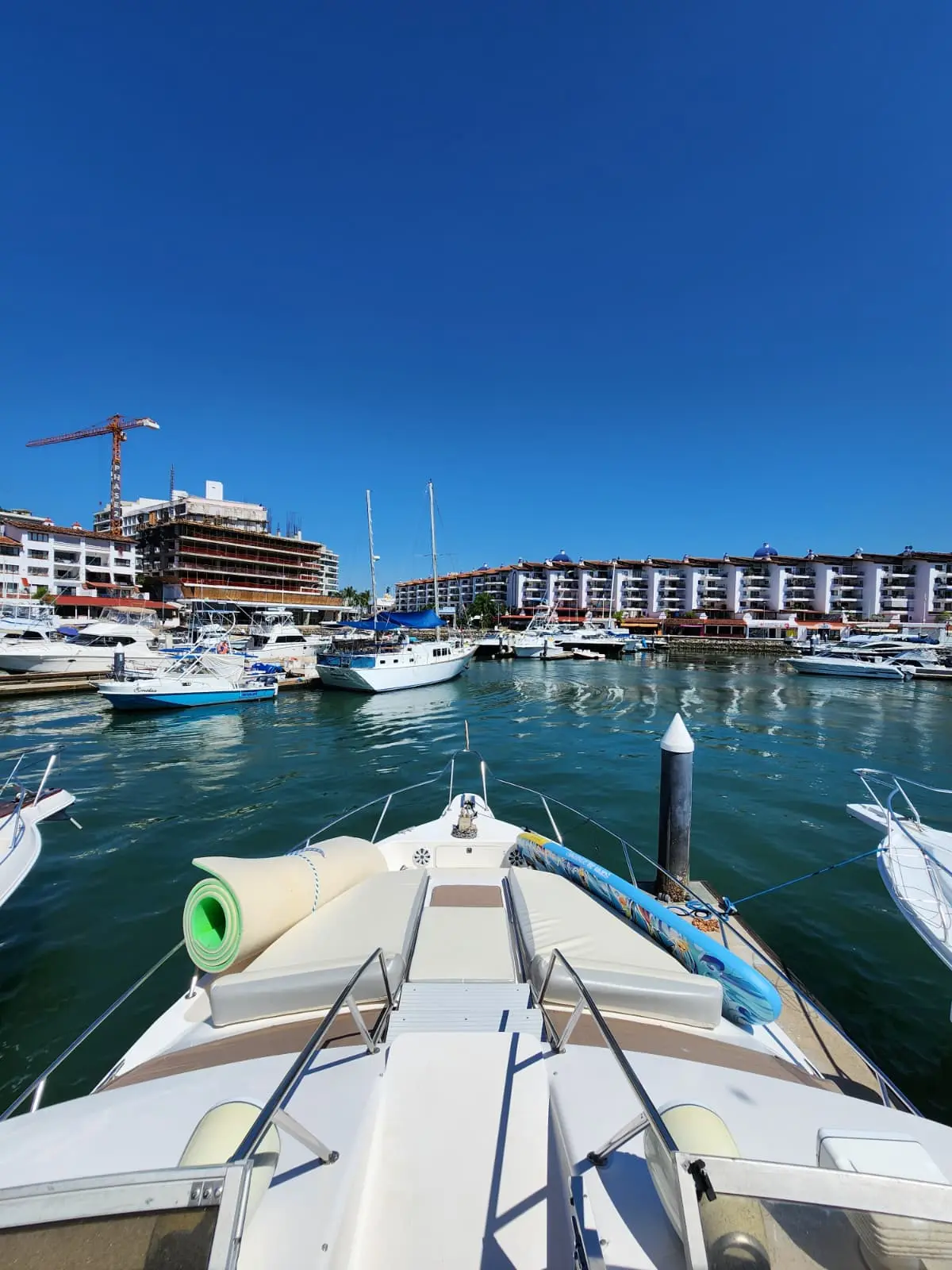 View over the yacht's bow to the marina and waterfront buildings of Puerto Vallarta