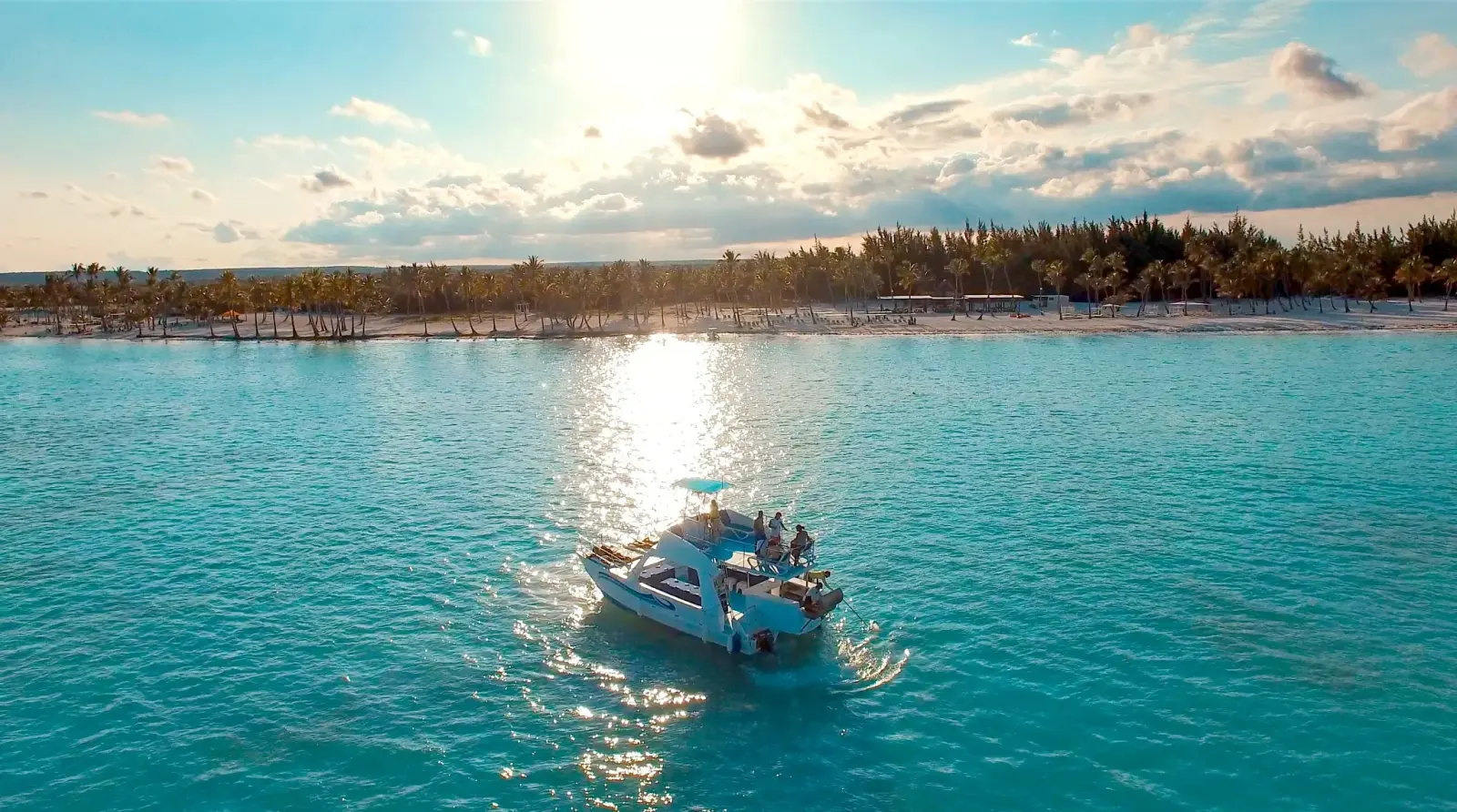 Boat with guests in sunlit turquoise water off the Miches coast, Dominican Republic