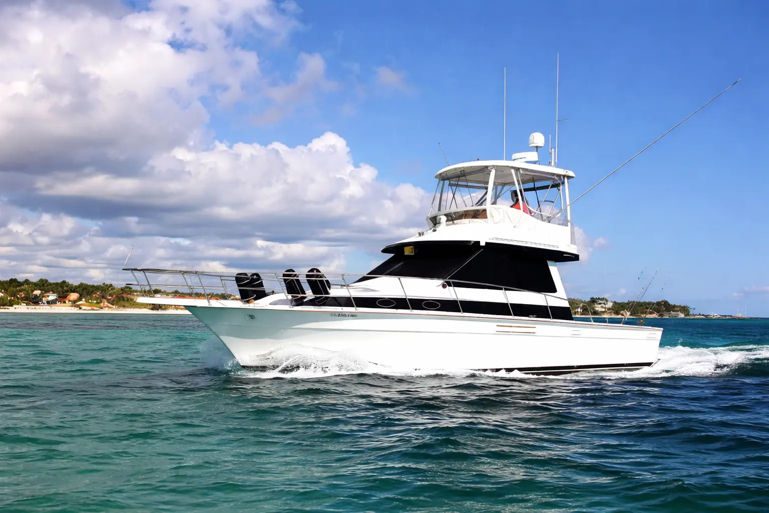 Flybridge sportfishing boat cruising along the coast off Punta Cana