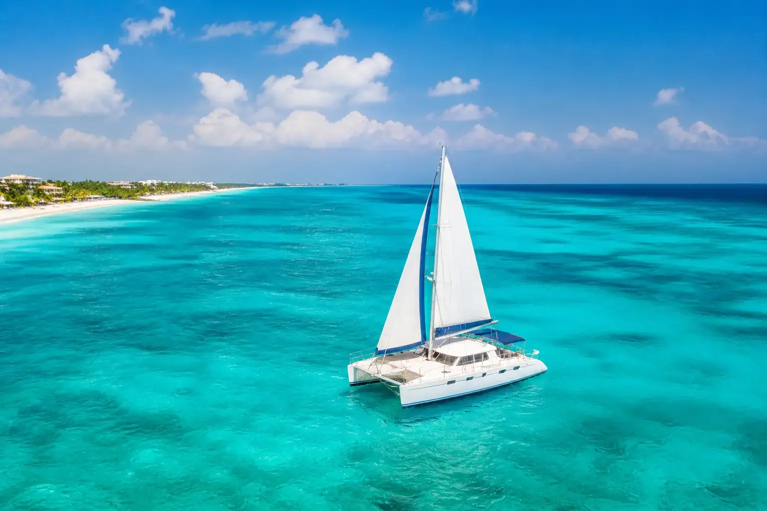Catamaran sailing on turquoise water in Playa del Carmen showing one of the best things to do in Playa del Carmen