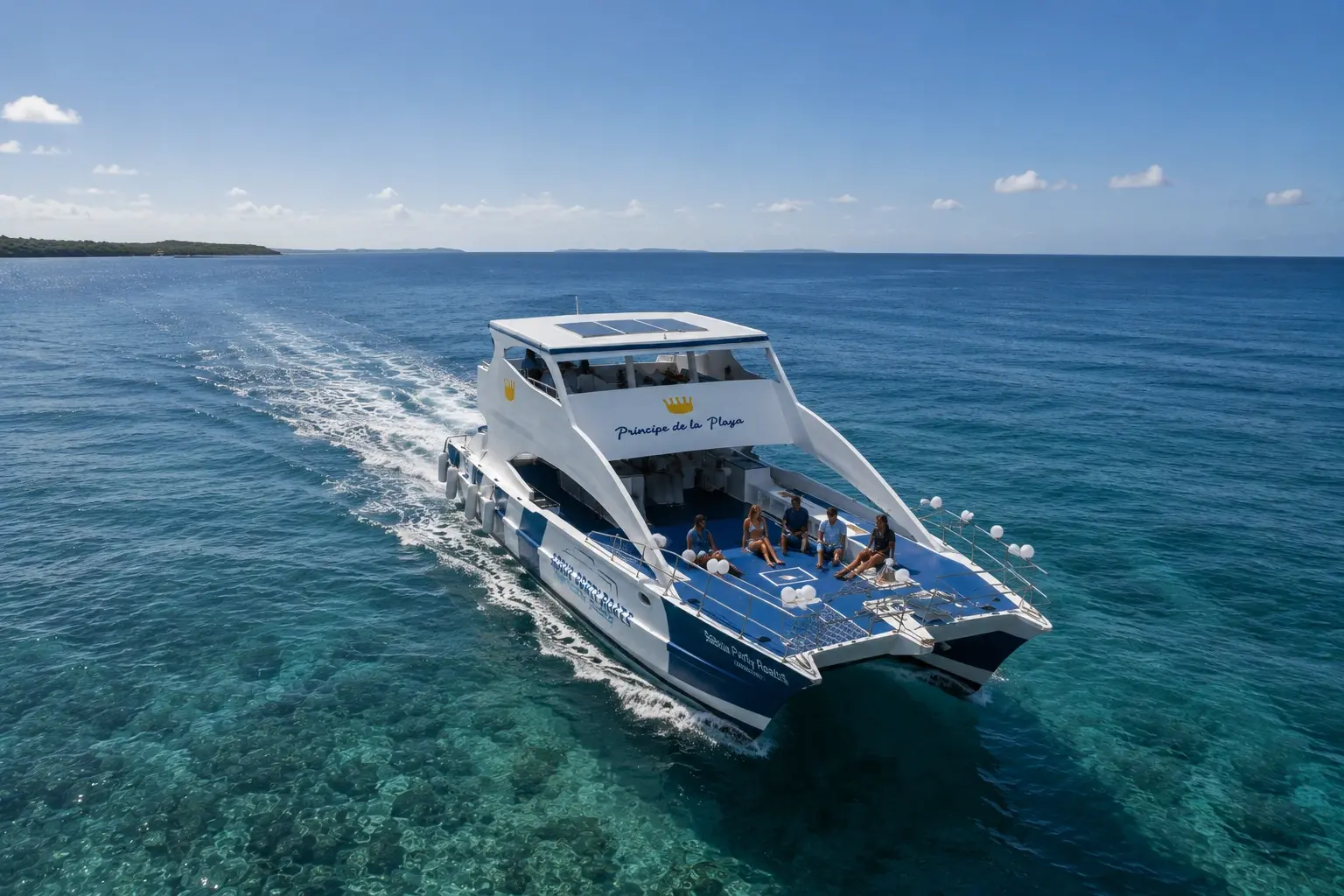 Cruise-friendly catamaran tour from Puerto Plata sailing over clear turquoise water with guests relaxing on deck
