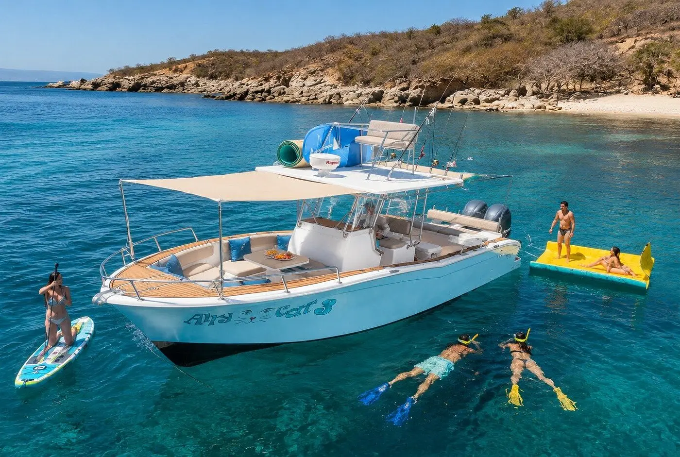 Aerial view of snorkelers, a paddleboarder and a floating mat around a center-console boat off Puerto Vallarta